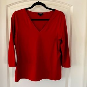 Worth three quarter sleeve V-neck is nylon and elastic
